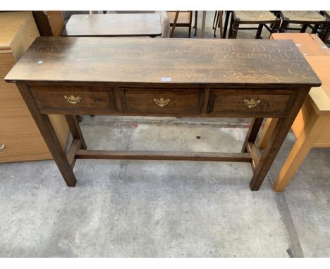 AN OAK CONSOLE TABLE WITH THREE DRAWERS AND BRASS  HANDLES, 54" WIDE