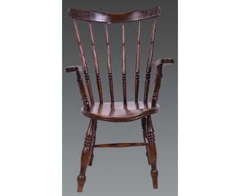 Elm and stained wood comb back kitchen chair, solid circular seat, open arms, turned legs, width 61cm.