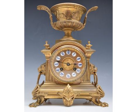 French gilt metal mantle clock, campana urn finial, enamel numerals, cylinder movement, striking on a bell, 31cm.