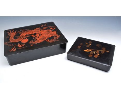 Far Eastern black lacquered oblong box, decorated with a dragon chasing a flaming pearl, 29cm, another box with painted decor
