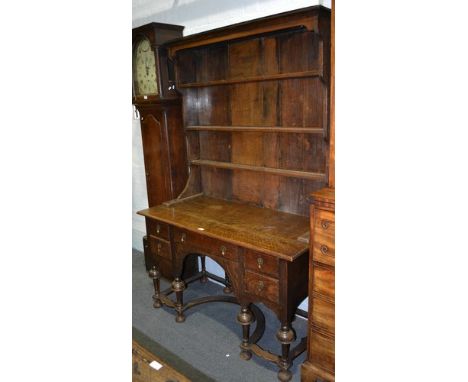 A George III mahogany bureau, the fall front enclosing a fitted interior, with a central cupboard, cupboard and pigeon holes,