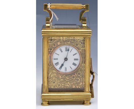French brass corniche type carriage clock, white enamel dial in an engraved foliate face, platform escapement, movement marke