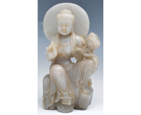 Sino-Indian hardstone model of a Buddhist Deity, seated, holding a lotus flower, 18cm.