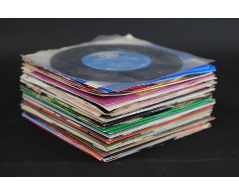 **Collection of Vintage 7-Inch Vinyl Singles**  A large assortment of vintage 7-inch vinyl records, featuring a diverse array