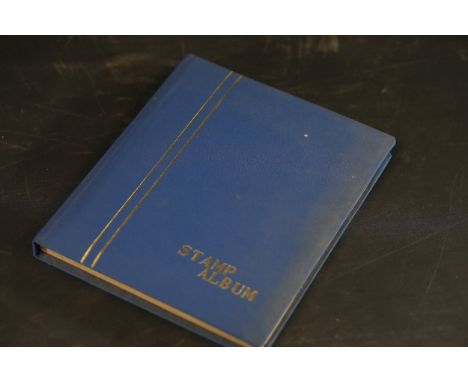 Victorian Stamp Collection in Blue Album  This item features a collection of vintage postage stamps housed in a blue hardcove