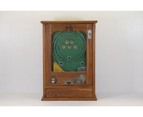 Vintage 1930s "Flick Ball" Wall MachineThis captivating 1930s "Flick Ball" wall machine is housed in a robust wooden cabinet,