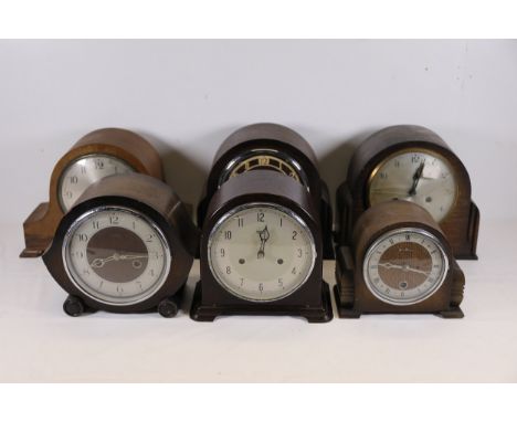 **Set of Vintage Mantel Clocks in Wooden Cases**  A set of six vintage mantel clocks, each featuring unique wooden cases and 