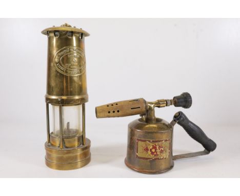 **Vintage Miner’s Safety Lamp and Brass Blow Torch**  A pair of vintage brass items, including:  1. **Miner’s Safety Lamp**: 