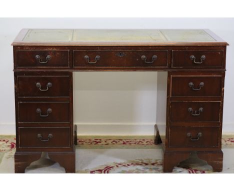 Wooden Pedestal Desk with Green Leather Inset Top and Brass-Handled DrawersThis wooden pedestal desk features a green leather