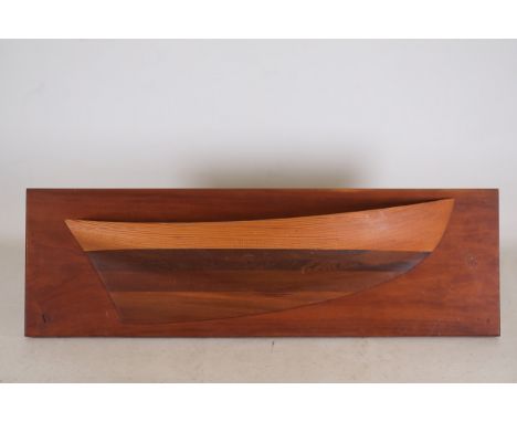 Half-Hull Wooden Ship Model  This item is a wooden half-hull ship model mounted on a polished rectangular wooden backboard, a