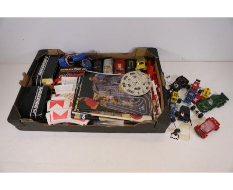 Collection of Scalextric Cars, Remote Controls, and Track Accessories with Original BoxesThis collection features an assortme