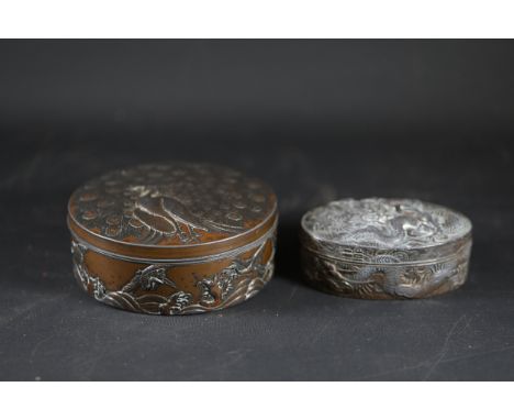 Collection of Two Decorative Metal BoxesThis collection comprises two intricate lidded metal boxes of differing sizes, featur