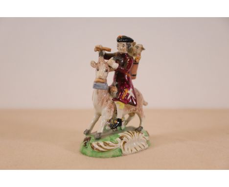 **Staffordshire Pearl Glazed Figure Group 'The Welsh Tailor'**A 19th-century Staffordshire pearl glazed earthenware figure ti