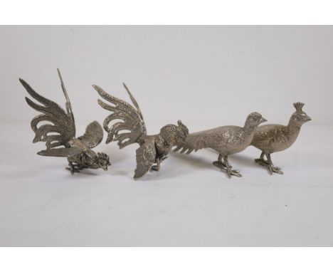 Set of Four Pewter Peacock Figurines: Fighting and Calm PosesThis collection features four exquisitely crafted pewter ornamen