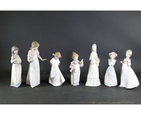 Group of Seven Nao Porcelain FigurinesA collection of seven glazed porcelain figurines, handcrafted in Spain by Nao (a brand 