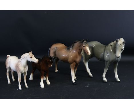 **Collection of Four Ceramic Horse Figurines Including Melba Ware Grey Stallion**This collection features four distinctive ce