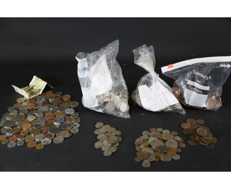 **Assorted Coins and a Banknote Collection**A diverse collection featuring assorted coins and one banknote. The coins vary in
