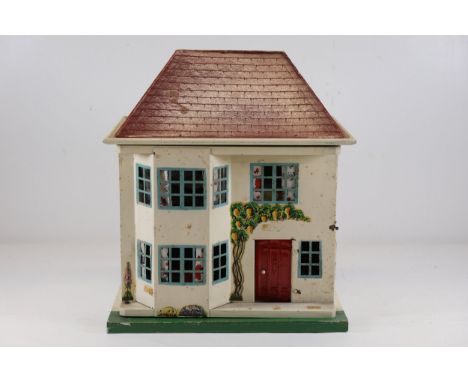 **Mid-20th Century Tin-Fronted Dolls' House with Furniture**This is a vintage tin-fronted dolls' house, likely British in ori