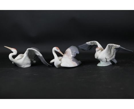 **Set of Three Retired Lladró Porcelain Crane Figurines Sculpted by Salvador Debón (1989-1997)**This collection includes thre