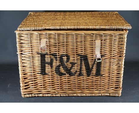 Fortnum &amp; Mason Wicker Hamper with Leather StrapsA rectangular wicker basket branded "F&amp;M," indicating its origins wi