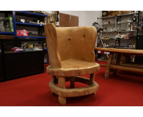 **Handcrafted Wooden Armchair by Maxie Lane**  A distinctive wooden armchair crafted by Maxie Lane, a locally renowned artist