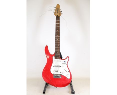 **Peavey Electric Guitar - Red Stratocaster-Inspired Design**A Peavey solid-body electric guitar with a vibrant red high-glos