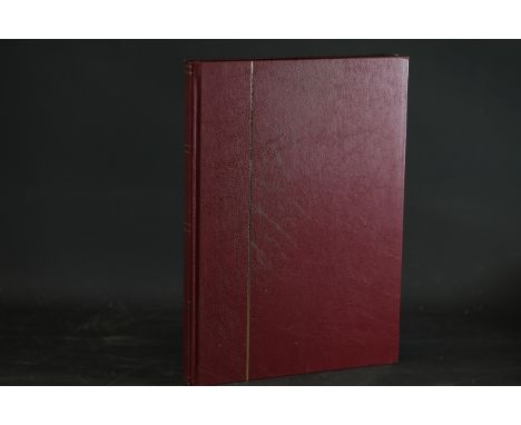 **Vintage Postage Stamps in Burgundy Hardcover Album**  This item comprises a curated collection of vintage postage stamps sy