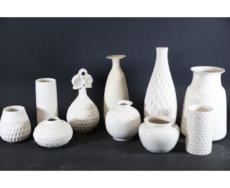 Collection of White Textured Ceramic Vessels A collection of eleven decorative ceramic or pottery items, glazed in white or c