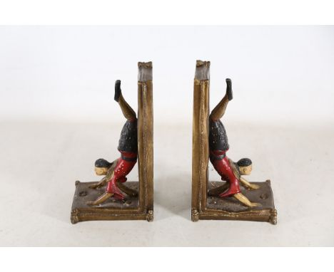 Pair of Vintage Acrobatic Bookends  A pair of vintage bookends featuring acrobatic figures performing handstands. Each figure