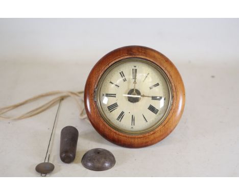 Antique Wooden Wall Clock with ComponentsA mid to late 19th-century wooden wall clock, featuring a circular polished wooden c