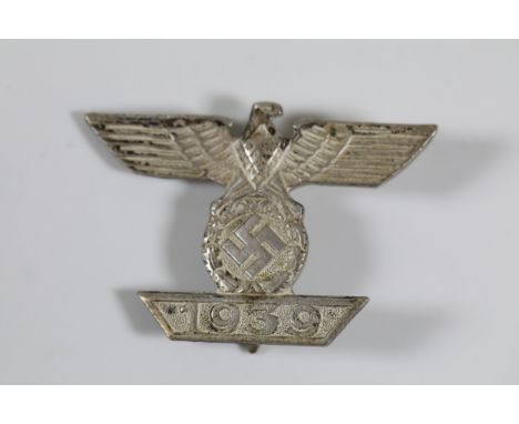 Silver-Toned WWII German Eagle Brooch with Swastika and 1939 InscriptionThis silver-toned brooch is intricately designed, sho