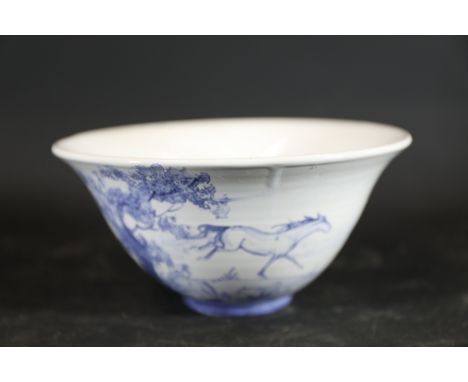 Blue-and-White Porcelain Bowl with Hand-Painted Motif  A medium-sized porcelain bowl featuring a flared rim, a tapered circul