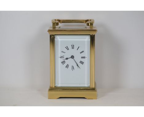 Vintage French Brass Carriage Clock with Roman NumeralsThis vintage brass carriage clock exhibits classic charm with its rect