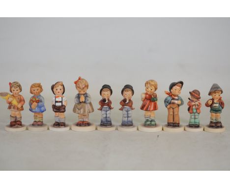 **Collection of Goebel Hummel Figurines: Detailed Porcelain Child Figures in Traditional European Attire**This exquisite coll