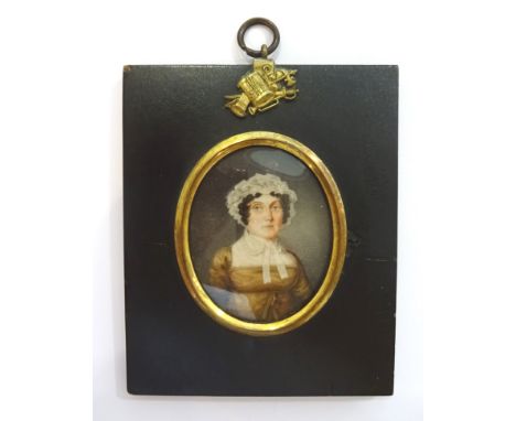 A miniature oval half length Portrait of an early 19th Century lady in papier mache frame decorated with a  Stand of Arms.  3