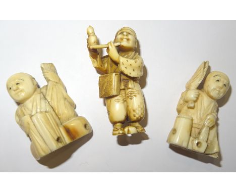 A Japanese ivory Netsuke in the form of a man playing a pipe.  2" (5cms) high and two other Netsuke. 