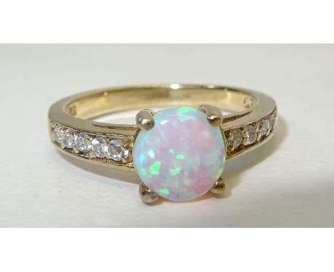 A silver gilt Dress Ring set with an opal and cubic zirconia.