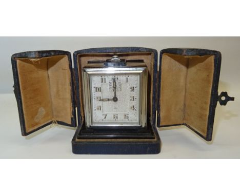 A 1930's Art Deco French Travel Alarm Clock, by JAZ, in a chromium plated case and leather travelling case.  4" (10cms) high 
