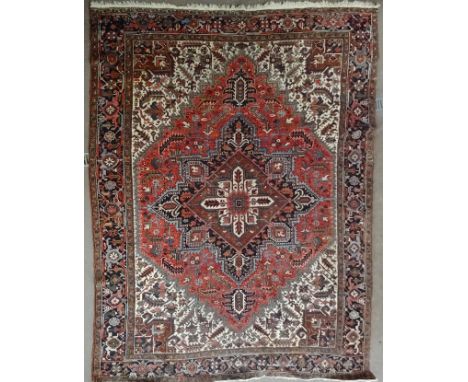 A Central Asian Carpet with a centre lozenge shape medallion and stylised floral decoration on a beige field and bordered.  1