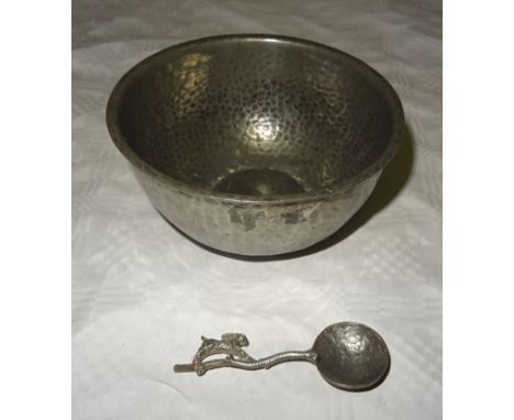 A Newlyn hammered pewter circular Bowl.  5 1/2" (14cms) diameter and a pewter caddy spoon, with the stem formed as a running 