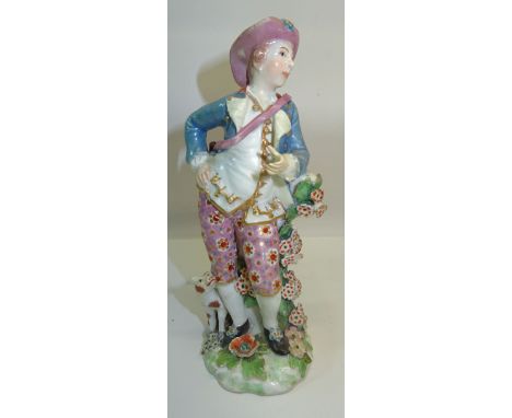 A Chelsea style standing figure of a man with a dog, leaning on a tree stump and on floral encrusted base, impressed mark 'R'