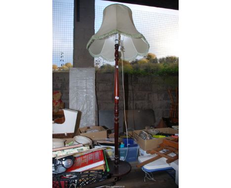 A wooden standard lamp and shade.
