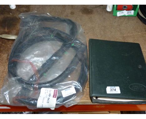 A Landrover Defender 90, 110, 130 book and a Landrover rubber door surround