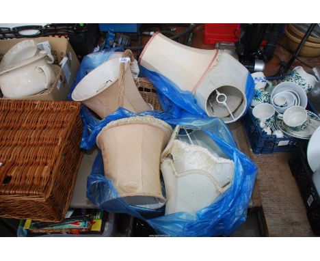 A wicker basket and quantity of lamp shades.