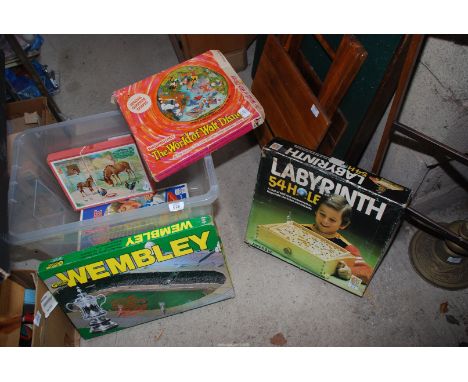 A box of children's games including a wooden Labyrinth game.