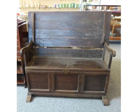 A panelled oak monk's bench, 18th century and later, 123cm wide