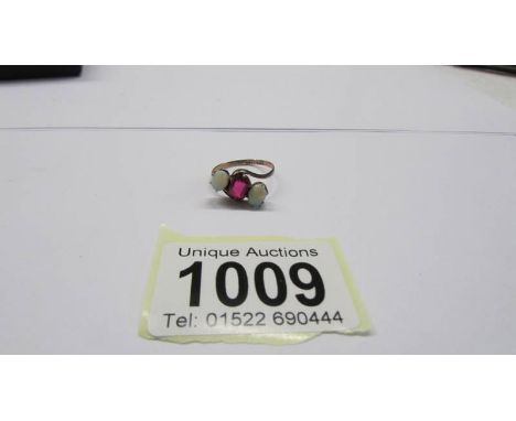 An opal and ruby gold ring, size M, 1.64 grams.