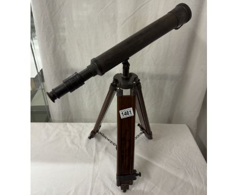 A patinated brass telescope on tripod base. Length 43cm
