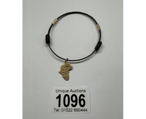 A vintage hair bangle depicting cave art stamped 9ct gold.