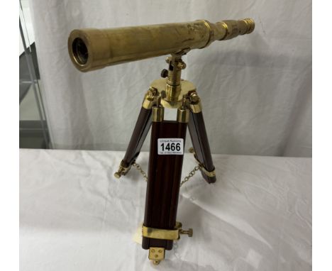 A brass telescope on tripod base. Length 37cm